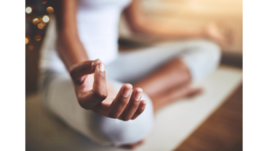 woman of color meditating hand up close to prevent overthinking, back pain and more